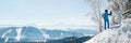 Panoramic shot of a female skier resting on top of the mountain observing nature at ski resort Royalty Free Stock Photo