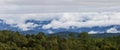 Panoramic shot of fog flow through Ob Luang mountain valley, Chaingmai in morning light during rainy season, Thailand Royalty Free Stock Photo