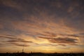 Panoramic shot of a golden sunset over the roofs of San Siro in Milan with orange clouds in the sky Royalty Free Stock Photo