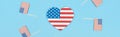 Panoramic shot of heart made of stars and stripes near decorative american flags on wooden sticks on blue background. Royalty Free Stock Photo