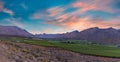 Panoramic shot of Hex River valley wine farms and mountains with golden cloud sky