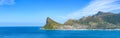 Panoramic shot Hout Bay with rugged coastal mountain and blue sea