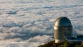 Panoramic shot of the La Palma astronomical observatory on a sea of clouds background Royalty Free Stock Photo