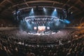 A panoramic shot of a large concert stage with the band playing to a massive audience. Generative AI