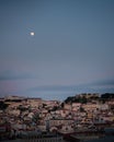 Panoramic shot of Lisbon Portugal on night time with a beautiful moon above Royalty Free Stock Photo