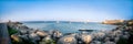 Panoramic shot of multiple sailboats docked along the tranquil shoreline of a tranquil bay Royalty Free Stock Photo