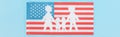 Panoramic shot of paper cut white family on national american flag on blue background. Royalty Free Stock Photo