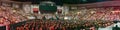 Panoramic shot of people and students filling the hall of UMass graduation event in Amherst MA, USA