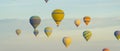 Panoramic shot presenting main touristic attraction in the city of Cappadocia, Turkey. Hit-air balloon travel. Stunning