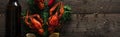 Panoramic shot of red lobsters, lemon slices, dill and glass bottle with beer on wooden surface. Royalty Free Stock Photo