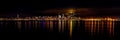 Panoramic shot of the reflection of the lights and buildings of Seattle, USA in the water at night