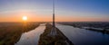Panoramic shot of the Riga Radio and TV Tower surrounded by a river during the sunset in Latvia Royalty Free Stock Photo