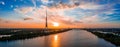 Panoramic shot of the Riga Radio and TV Tower surrounded by water during the sunset in Latvia Royalty Free Stock Photo