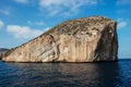 Panoramic shot of a rock island on thin cloud background