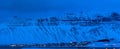 Panoramic shot of settlements on the mountainside in Longyearbyen, Norway, under the cloudy sky