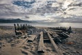 Panoramic shot of a shipwrecked boat on the shore of Rossbeigh strand