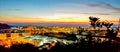 Panoramic shot of a silhouette of a plant an industrial city during sunset Royalty Free Stock Photo