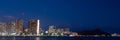 Panoramic shot of he skyscrapers on the beach of Waikiki in Honolulu, Hawaii at night Royalty Free Stock Photo