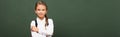 Panoramic shot of smiling schoolgirl standing Royalty Free Stock Photo