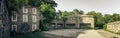 Panoramic shot of a stone-walled house on a sunny day