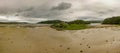 Panoramic shot of the Tioram Castle by a lake and forests Royalty Free Stock Photo