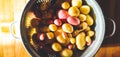 Panoramic shot of a variety of potatoes in a strainer pot