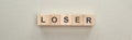 Panoramic shot of wooden blocks with loser word on grey background, bullying concept. Royalty Free Stock Photo