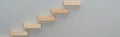 Panoramic shot of wooden blocks symbolizing career ladder isolated on grey with copy space.