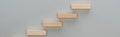 Panoramic shot of wooden blocks symbolizing career ladder isolated on grey.