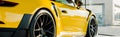 Panoramic shot of yellow luxury porshe in car showroom