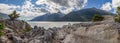 Panoramic shot from Yucatania point near Skagway, Alaska. Rocky terrain as a foreground. Mountains and cloudy blue sky as a Royalty Free Stock Photo