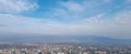 Panoramic skyline and buildings with blue sky and white clouds.