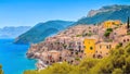 Panoramic of a small and colorful Mediterranean coastal village between the sea and the mountains