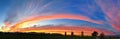 Panoramic Striking Sunset Background With Vivid Orange, Blue, Red And Yellow, In The Shape Of A Rainbow.