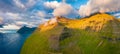 Panoramic summer view from flying drone of Sydradalur village hills, Kalsoy island. Low clouds morning scene of Faroe Islands, Den