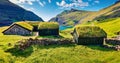 Panoramic summer view of Saksun village with typical turf-top houses and Saksunar Kirkja, Faroe Islands. Sunny morning scene of St