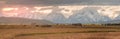 Panoramic sunrise of Wyoming ranch with Grand Teton in the Background