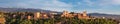 Panoramic sunset hour time of Alhambra medieval palace and fortress complex with Sierra Nevada snowy mountains in Granada, Royalty Free Stock Photo