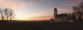Panoramic sunset scenery with fog over the fields and chapel