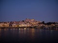 Panoramic sunset view of Coimbra old historical center on hill and Ponte de Santa Clara bridge river Mondego Portugal Royalty Free Stock Photo