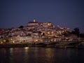 Panoramic sunset view of Coimbra old historical center on hill and Ponte de Santa Clara bridge river Mondego Portugal Royalty Free Stock Photo