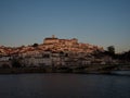 Panoramic sunset view of Coimbra old historical center on hill and Ponte de Santa Clara bridge river Mondego Portugal Royalty Free Stock Photo