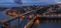 Panoramic sunset view of Porto Portugal cityscape with Dom Luis I Bridge and Douro River Royalty Free Stock Photo