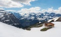 Panoramic Swiss Alps mountain range landscape with wooden cottage in Grindelwald, Switzerland Royalty Free Stock Photo