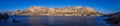 Panoramic of the Telendos island in Greece surrounded by blue seascape against a blue sky