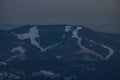 Panoramic telephoto view of Cerkno ski slope in slovenia viewed from Soriska planina on a cloudy day