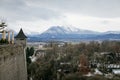 Panoramic top scenery of outskirts of city, viewpoint at Hohensalzburg Fortress, during cloudy and gloomy winter day, mountains Royalty Free Stock Photo