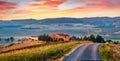 Panoramic Tuscanian view with old country road. Magnificent summer sunrise on Italian countryside. Traveling concept background