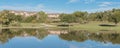 Panoramic urban park with lake reflection and apartment complex in background near Dallas
