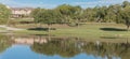 Panoramic urban park with lake reflection and apartment complex in background near Dallas